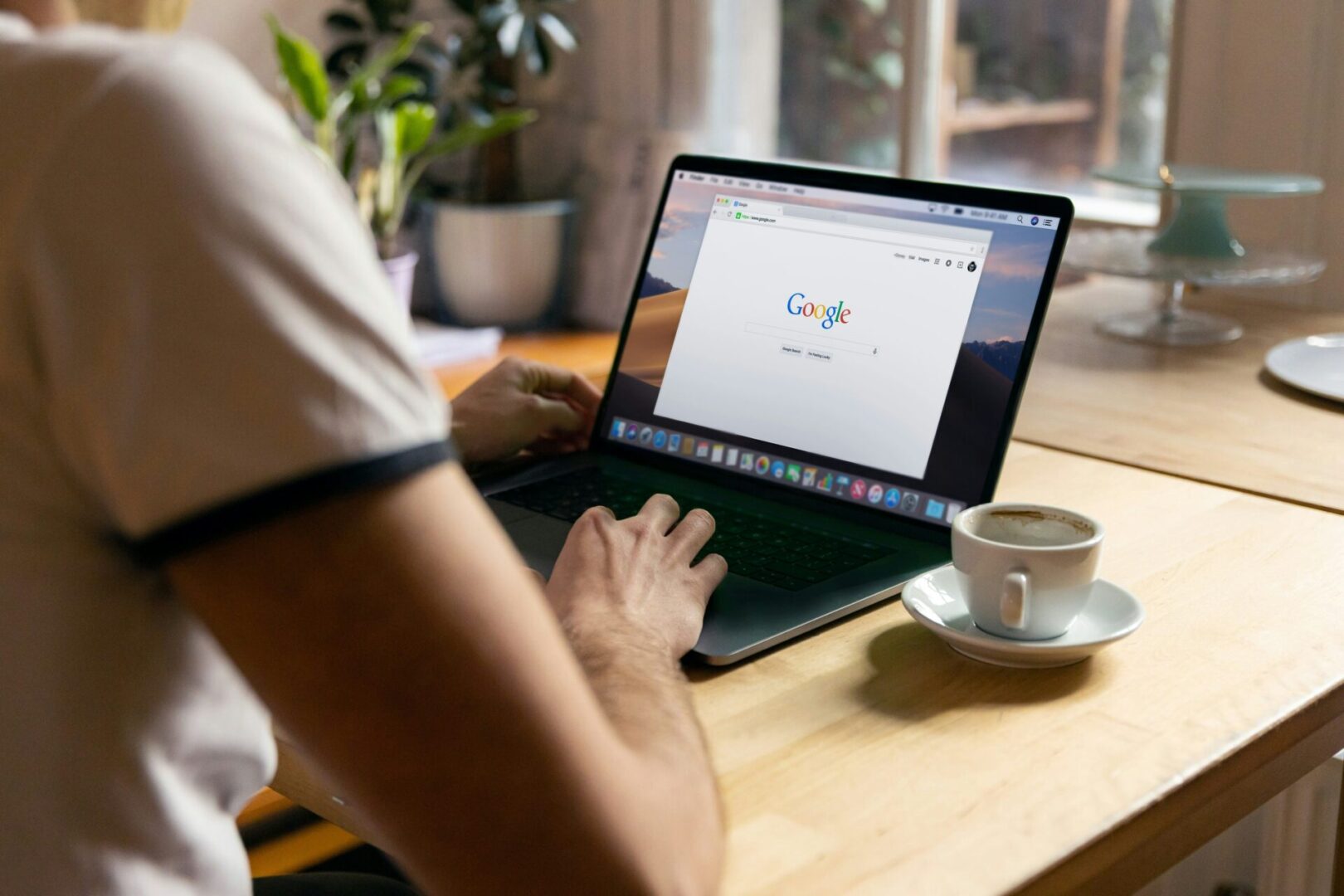 A person sitting at a table with a laptop.